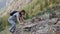 Girl climber climbs a steep rock.