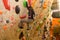 Girl climbing on practical wall indoor, bouldering training