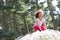 Girl Climbing On Rock In Countryside