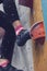 Girl climbing up on wall in gym, focus on feet