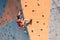 A girl climbs a climbing wall