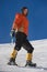 Girl climbs the mountain through snow blown away by the strong wind.