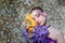 girl with closed eyes and fancy creative make-up holding iris flowers bouquet