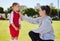 Girl, coach and soccer for motivation, inspiration and help on field for better performance in sport. Woman, child and