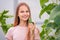 Girl collects cucumbers in the summer in a greenhouse