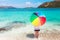 Girl with color full umbrella on the sandy beach