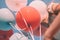 Girl with colorful balloons up in the sky. Low angle. Retro look