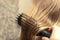 The girl combs her hair with a comb in the bathroom. Place for your text. Home hair care concept