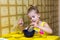 girl concentrating dunk the bread in a cup