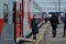 Girl conductor stands near the railway passenger car of the new double-decker train 066 Togliatti - Moscow waiting for passengers