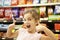 Girl in confectionery supermarket confectionery aisle