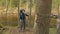 Girl considers the metall suspension bridge through the river and smiles