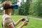 The girl controls a quadrocopter in the park with the help of a VR helmet. The concept of virtual reality. extra reality