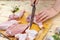 Girl cook butchering a chicken thigh. Parts of a chicken carcass on a cutting Board