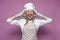 Girl cook in uniform, apron and gloves for baking screaming on a colored background, beautiful woman housewife in kitchen clothes