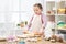 Girl cooking in home kitchen, making dough, healthy food concept