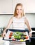 Girl cooking trout fish in pan