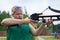 A girl with a crossbow aiming at a target