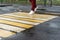 A girl crosses the road at a pedestrian crossing