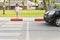 The girl crosses the street at a pedestrian crossing