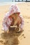 Girl crouching on the beach