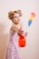 girl in curles pointing by spray bottle at