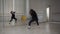 A girl with curly hair conducts an online class on modern dance at her own dance school with a large mirror.