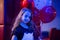 Girl cute smiling child hold bunch balloons lighted with blue light. Girl with balloons celebrate birthday in bowling