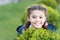 Girl cute smiling kid green grass background. Healthy emotional happy kid relaxing outdoors. What makes child happy