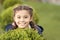 Girl cute smiling kid green grass background. Healthy emotional happy kid relaxing outdoors. What makes child happy