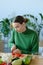 Girl cuts fresh tomatos on a cutting board