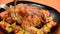 Girl cuts Roasted chicken or grilled turkey for Christmas or Thanksgiving in sauce with potatoes vegetables and rosemary