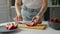 Girl cuts strawberries in a bright kitchen. Healthy food