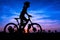 Girl cycling at mountain twilight time
