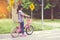 Girl is cycling in the park, bicycle stops at traffic lights