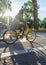 Girl cyclist in raincoat rides bicycle along the canal embankment in Paris