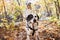 Girl with dalmatians dog on autumn season