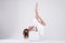 Girl in a dance pose on a white background. Flexibility, strength