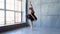 Girl dancer in ballet school learns to dance. Little ballerina in training in black dancing suit. Children`s ballet