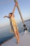 Girl dancing on deck of yacht