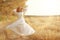 Girl dancing in field in white dress