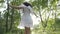 Girl dancing happily in the woods dressed in a angelic white dress -