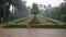 A girl is dancing in a red raincoat in the rain