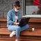 The girl with dark hair in a white medical mask and blue jeans.