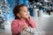 girl with dark skin color lies under the Christmas tree. cute mulatto is celebrating the new year. African girl, gifts