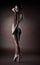 girl in dark stand topless on ballet pointes