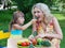 Girl daughter kid child feeding mother mum with cucumber