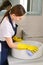 Girl decided to arrange cleaning in the house. House cleaning in yellow gloves.