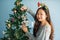 girl decorate bell to christmas tree