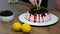 Girl decorates a cake Pavlova mint. Homemade meringue cake Pavlova with whipped cream.